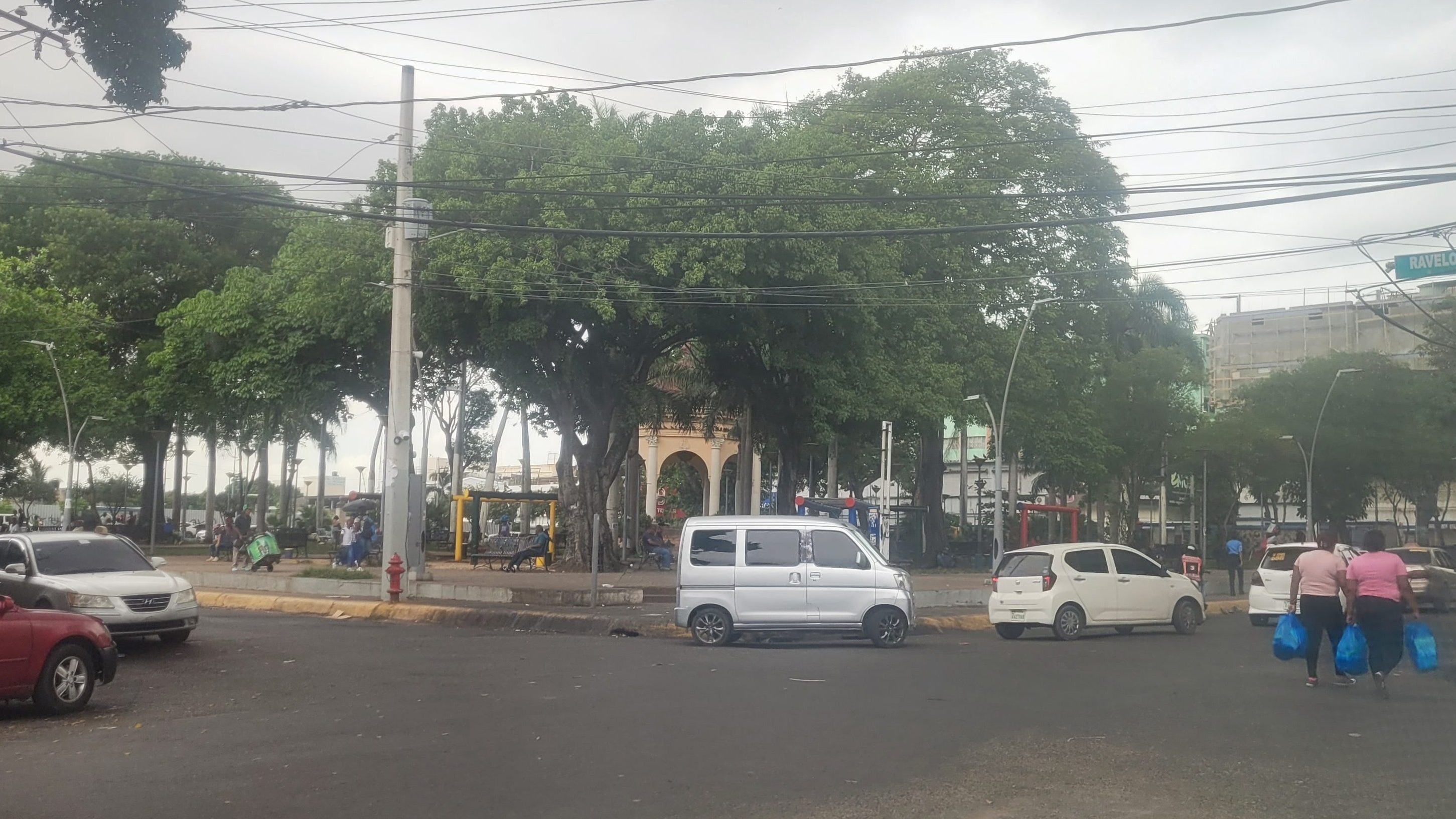 View of Parque Enriquillo in Santo Domingo with cars and surrounding trees