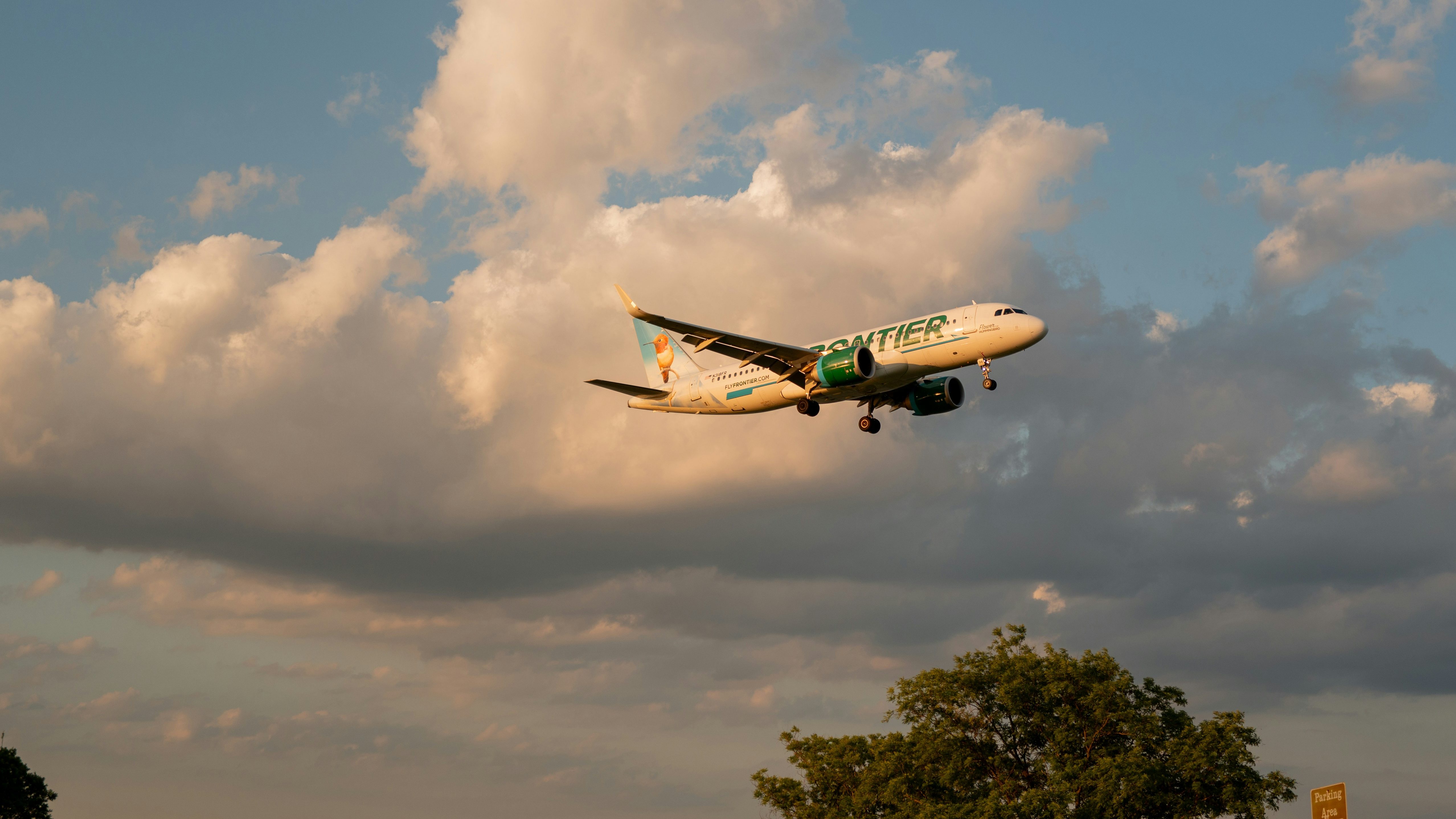 Frontier Airlines airplane flying in the sky.