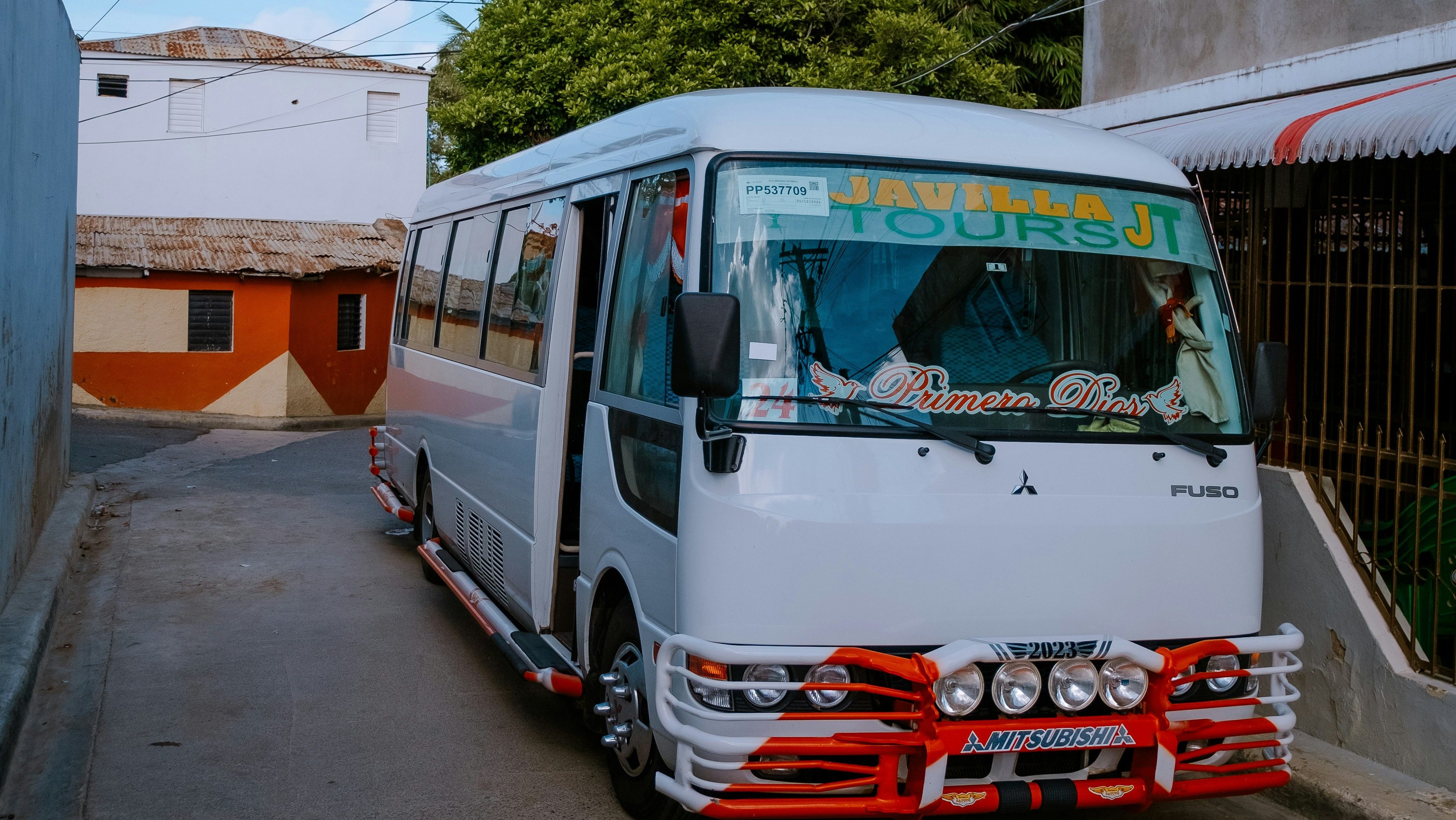 Typical Dominican guagua used for public transportation with passengers and bright colors